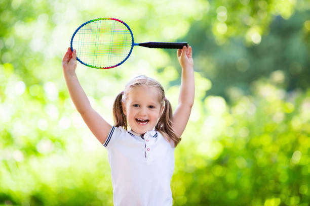 child playing badminton or tennis outdoor in summer - 11275 imagens e fotografias de stock