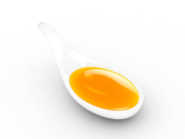 virgin olive oil in a porcelain spoon - cooking oil olive oil nutritional supplement spoon imagens e fotografias de stock