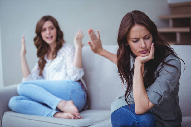 Two female friends arguing with each other stock photo