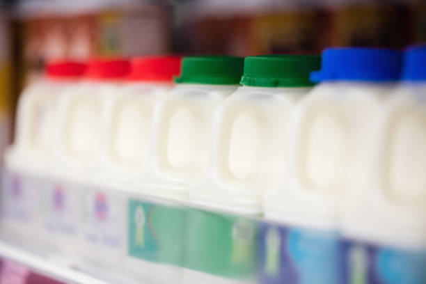 Empty glass bottles for recycling and reuse - milk bottles from United Kingdom in a crate ready for collection by a milk man