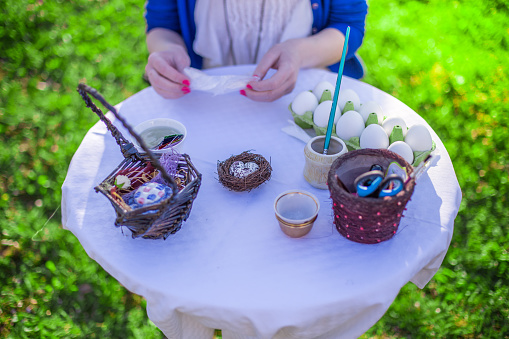 Decorating easter eggs with paint and decoupage for holiday in the garden