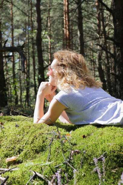 istock Woman lying in the forest. 664061364