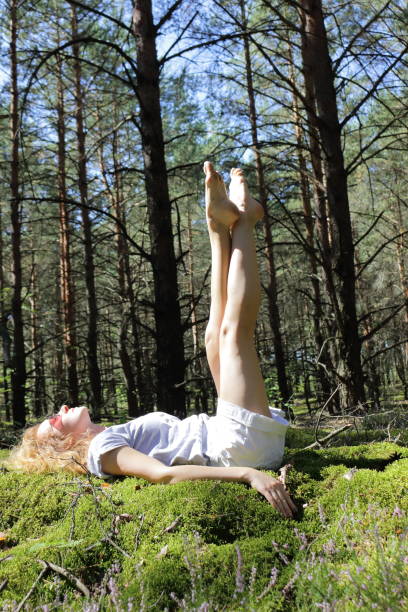 Woman lying in the forest. Woman lying in the forest. Vertical. women lying down grass wood stock pictures, royalty-free photos & images