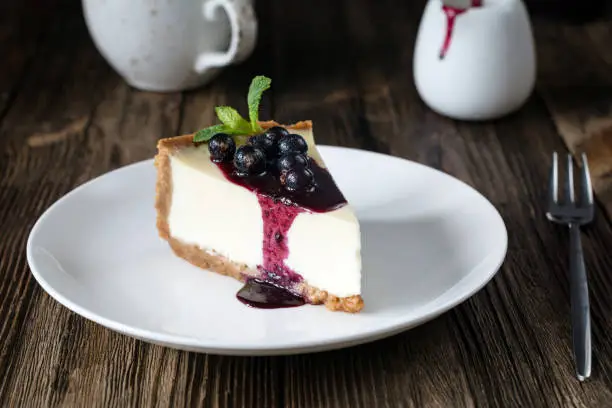 Photo of Plain cheesecake with black currant sauce