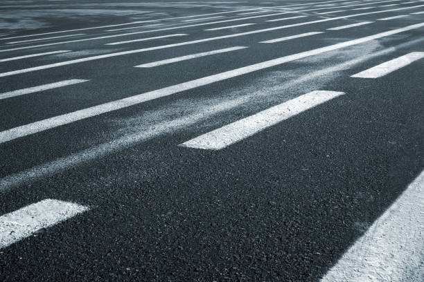 istock Lines on wet wide asphalt road perspective view. 664065226