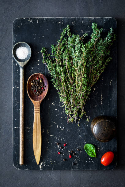 istock Thyme, sea salt, pepper and spices on cutting board 664065272