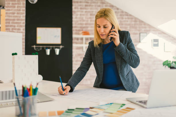 istock Pregnant woman Working in Her Office 664071576