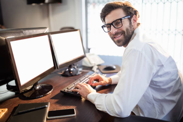 istock Businessman with glasses smiling and working 664072176