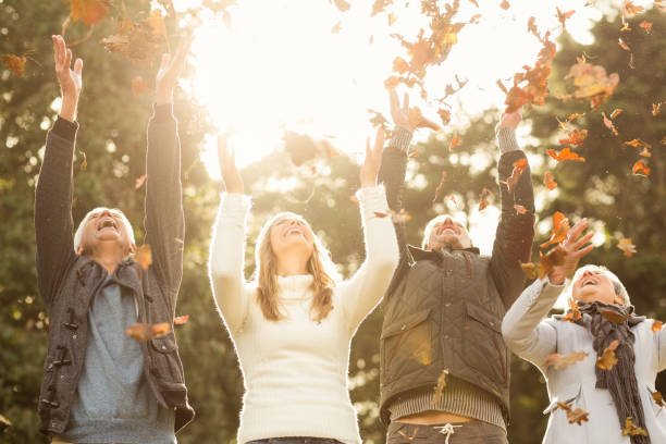 istock Happy family throwing leaves around 664074634