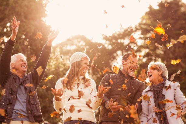 istock Happy family throwing leaves around 664074664