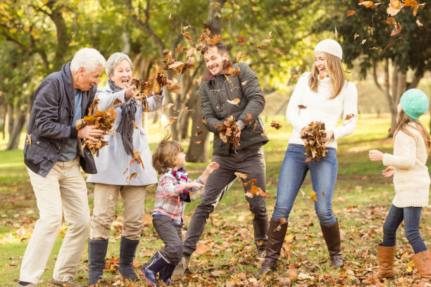 istock Happy extended family throwing leaves around 664074806