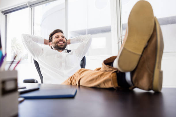 istock A smiling man relaxing in the office 664074832