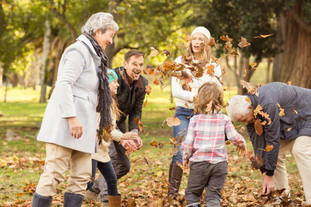 istock Happy extended family throwing leaves around 664074890
