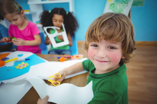 istock Happy kids doing arts and crafts together 664074950