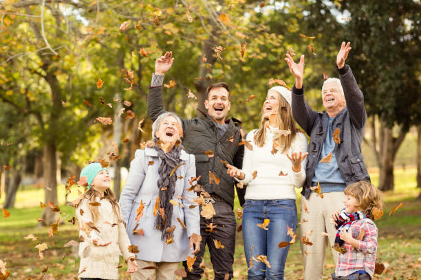 istock Happy extended family throwing leaves around 664074990