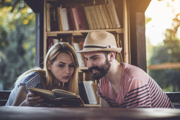 Beautiful young couple studying in the outdoors library