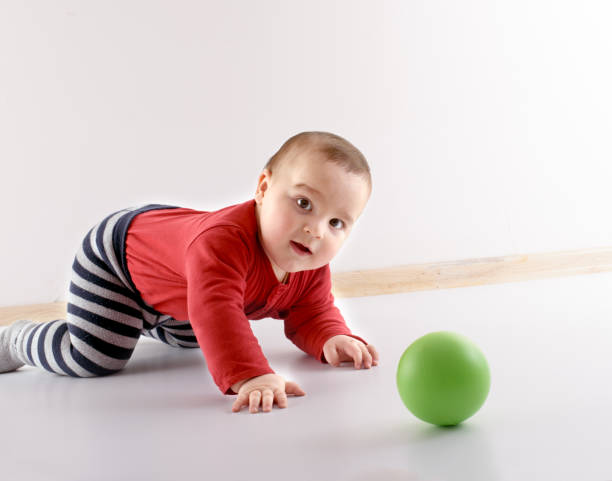 istock Cute baby playing with ball 664077442