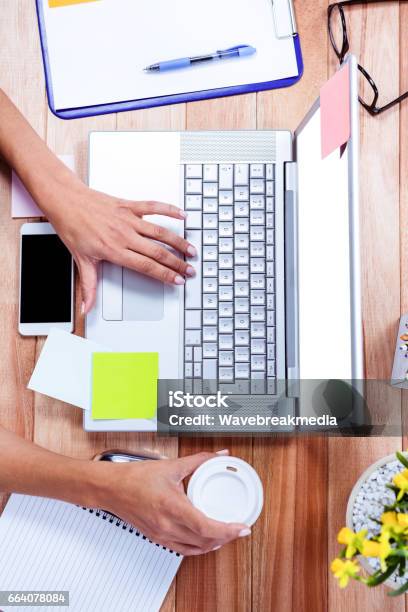 Overhead Of Feminine Hands Using Laptop And Holding Coffee Mug Stock Photo - Download Image Now