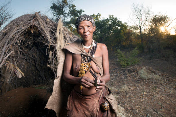 San woman portrait. GRASHOEK, NAMIBIA - 22ND MAY 2016 - A Ju Hoansi san woman poses for a photograph. The San now display their culture in Living museums. These Museums preserve the culture as well as providing income. bushmen stock pictures, royalty-free photos & images