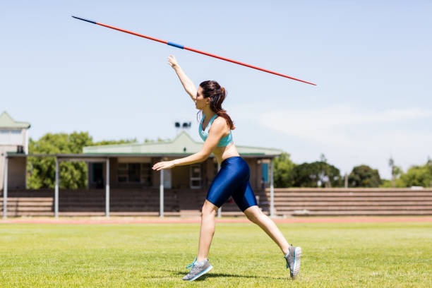 Female athlete throwing a javelin Female athlete throwing a javelin javelin stock pictures, royalty-free photos & images