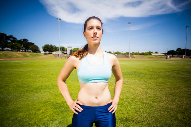 istock Confident female athlete standing with hand on hip 664081148