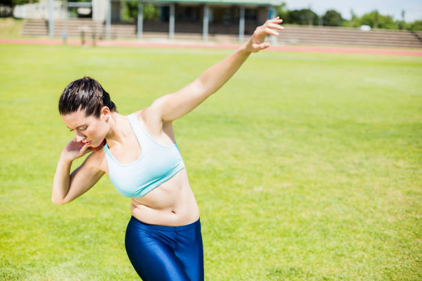 istock Female athlete preparing to throw shot put ball 664081228