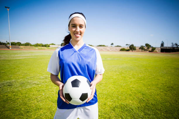 istock Happy soccer player standing with a ball 664081460