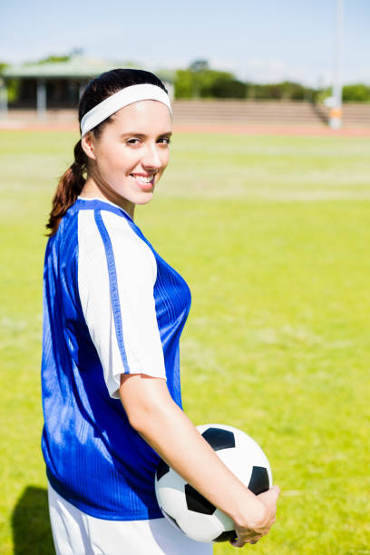 istock Happy soccer player standing with a ball 664083922