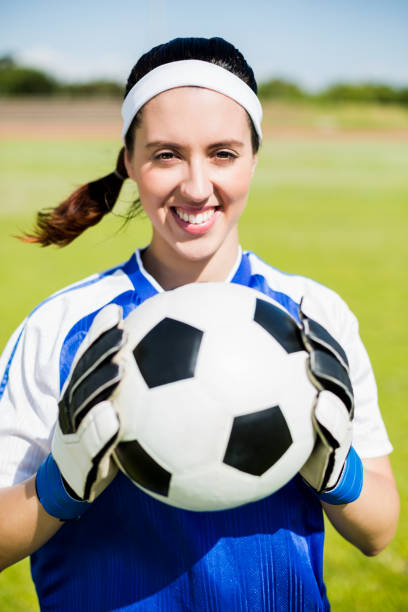 istock Happy soccer player standing with a ball 664084182