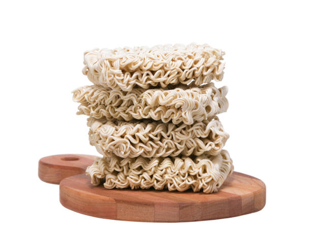 Ramen instant raw noodles on wooden plank front