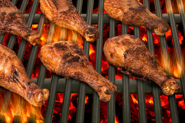 istock Top view of chicken drumsticks being grilled in a barbecue. 664090142