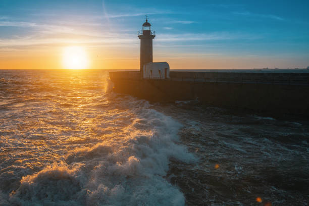 istock Beautiful ocean sunset and surf at the lighthouse. 664098644