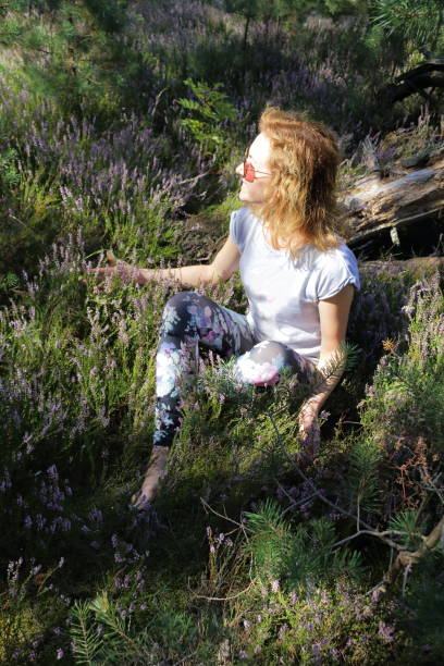 istock Woman sitting on a Sage flowers. 664113074