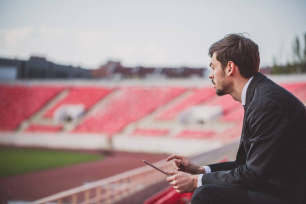 istock Handsome gentleman on bleachers 664118720