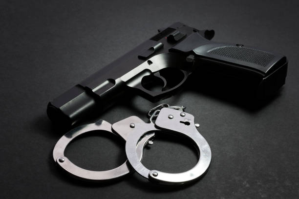 istock Handgun wih handcuffs 664119722