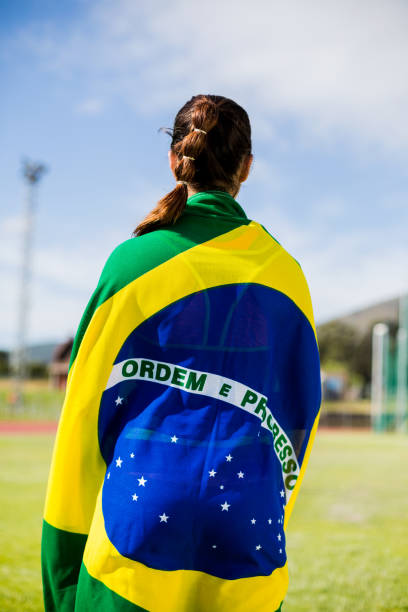 istock Female athlete wrapped in Brazilian flag 664122152