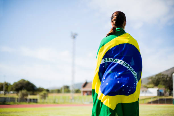Female athlete wrapped in Brazilian flag stock photo
