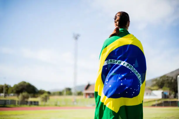 Rear view of athlete wrapped in Brazilian flag