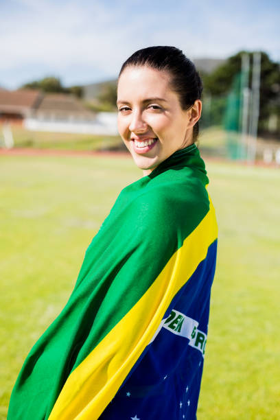 istock Female athlete wrapped in Brazilian flag 664122204