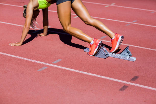 istock Female athlete ready to run on running track 664125254
