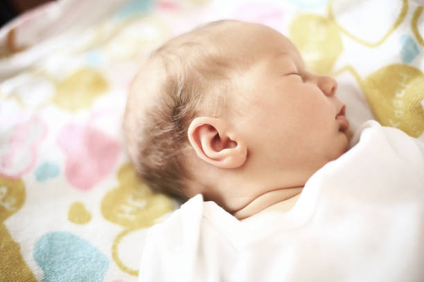 istock cute newborn baby sleeping peacefully in a cot 664125438