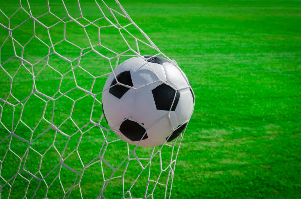 istock soccer ball in net 664135316