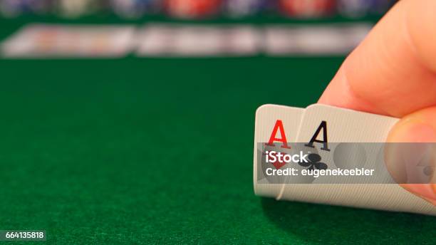 Poker Player Looks His Playing Cards In The Game Stock Photo - Download Image Now - Poker - Card Game, Ace, Pair