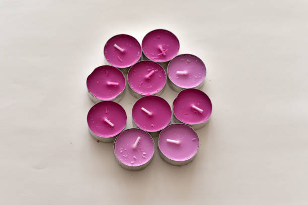 Beautiful purple fragrant candles on white color background