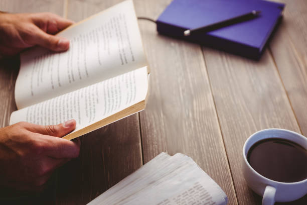 istock Person holding book at desk 664149868