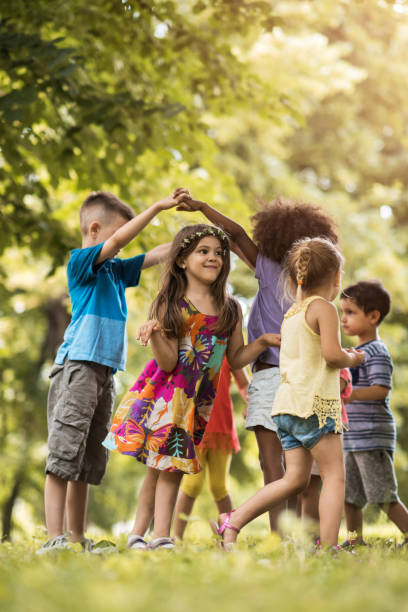 istock Group of small kids having fun while playing in nature. 664152284