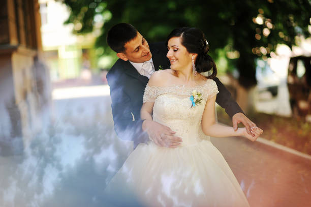 istock happy wedding couple embrace 664160644