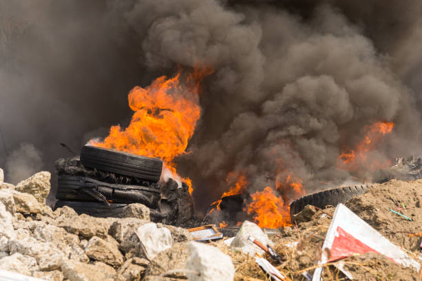 Burning rubber tires creating big black smoke and pollution.