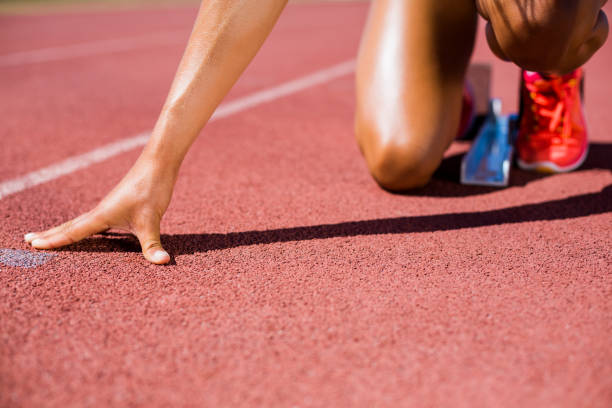 istock Female athlete ready to run on running track 664167188