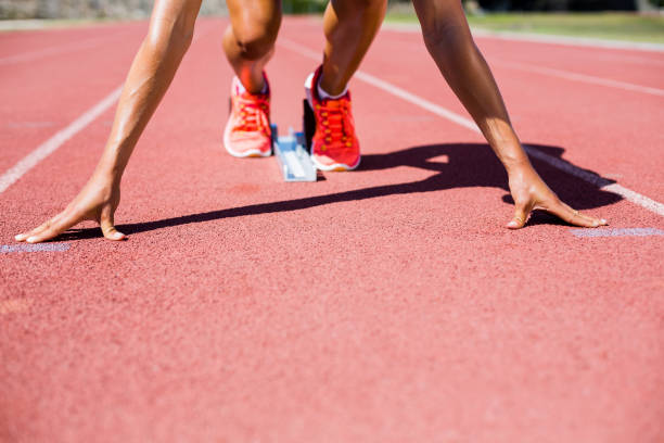 istock Female athlete ready to run on running track 664167446